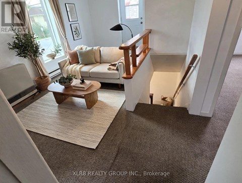 A living room with a white couch and a wooden coffee table.