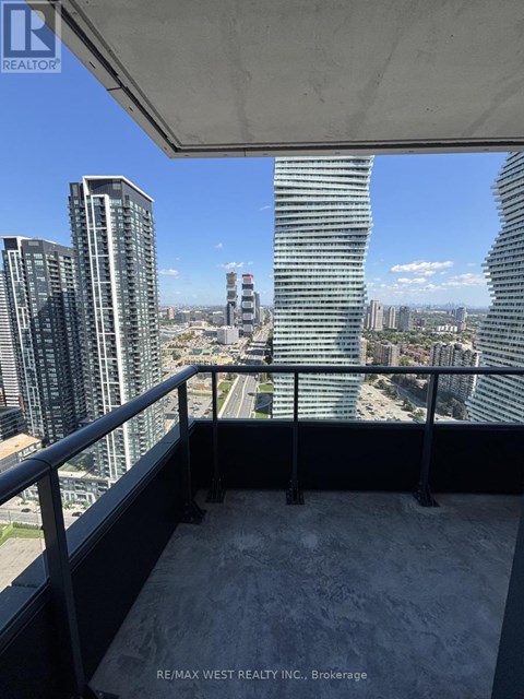 A balcony overlooks a cityscape with tall buildings.