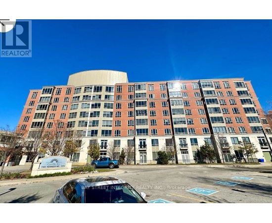 A large multi-story building with a parking lot in front.
