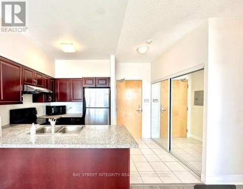 A kitchen with red cabinets and a counter top.