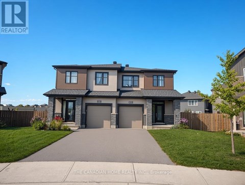 A house with a grey front yard and a driveway.