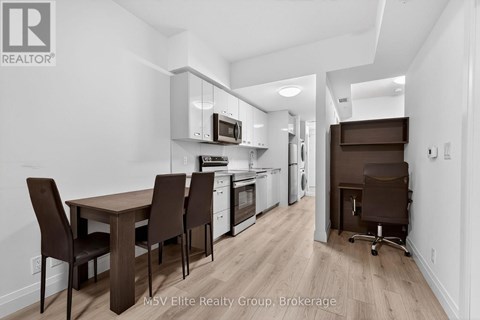 A kitchen with brown chairs and a wooden table.