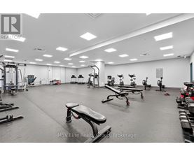 A gym with a variety of equipment including treadmills, weights, and exercise machines.