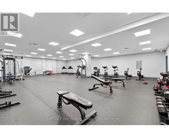 A gym with a variety of equipment including treadmills, weights, and exercise machines.