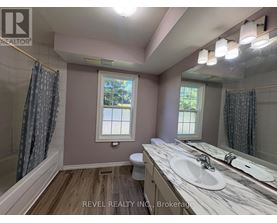 A bathroom with a marble countertop and a window.