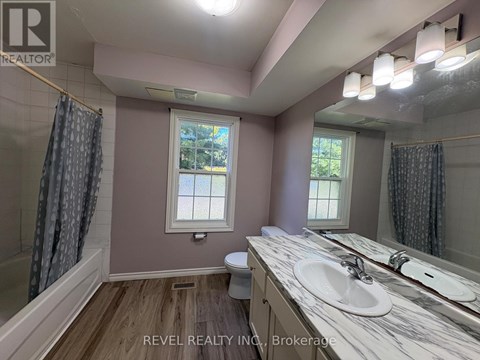 A bathroom with a marble countertop and a window.