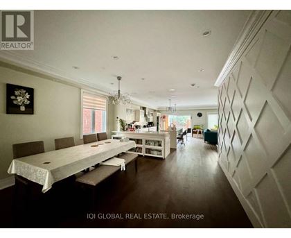 A dining room with a long table and chairs.