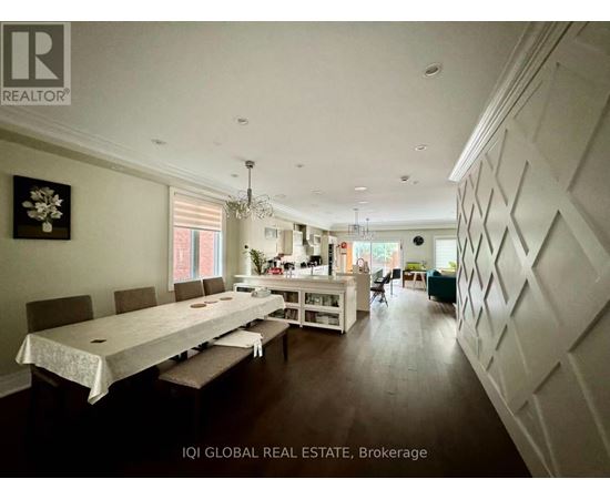 A dining room with a long table and chairs.