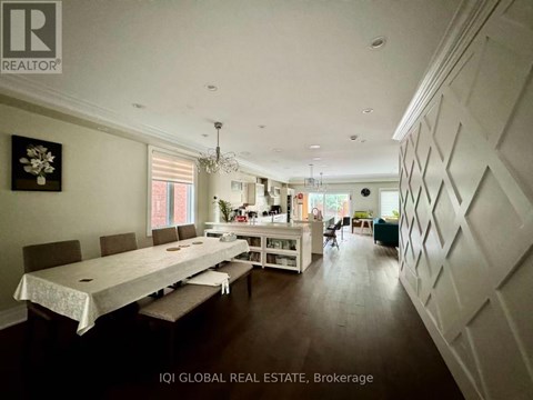 A dining room with a long table and chairs.