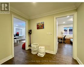 A brokerage office with a vacant room and a painting on the wall.