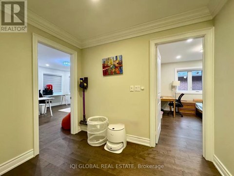 A brokerage office with a vacant room and a painting on the wall.