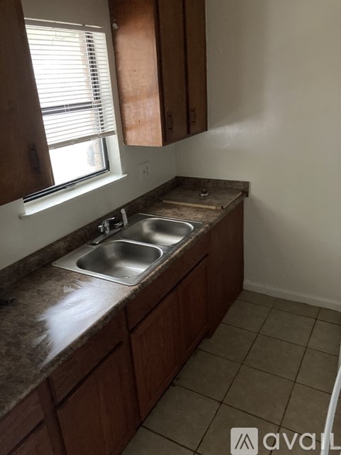 A kitchen with a sink and a window.