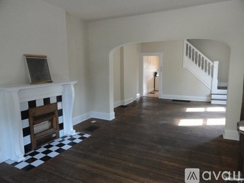 A living room with a fireplace and a checkered floor.