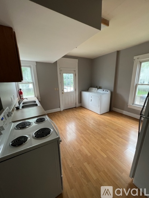 A kitchen with a stove top oven and a refrigerator.