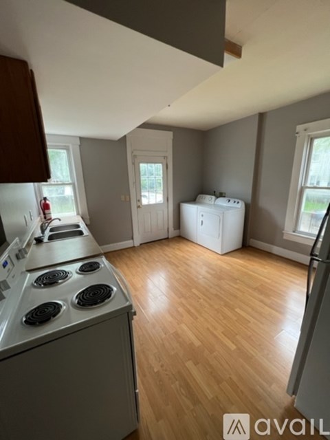 A kitchen with a stove top oven and a refrigerator.