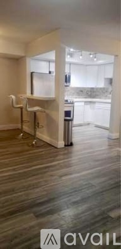 A modern kitchen with a bar area and a dining table.