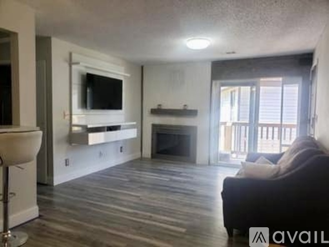 A living room with a fireplace and a television.