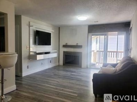 A living room with a fireplace and a television.