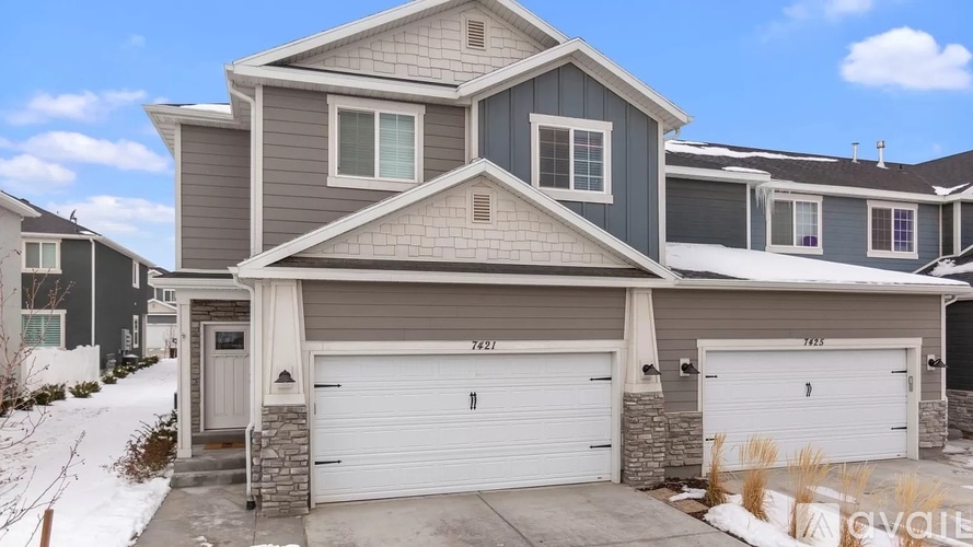 A house with a grey and white exterior is for sale.
