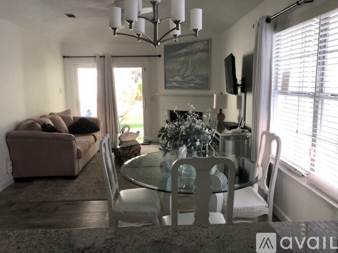 A living room with a glass table and chairs.
