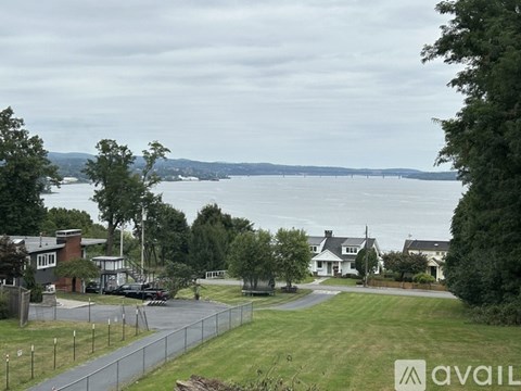 A view of a residential area with a body of water in the distance.