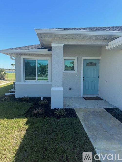A house with a blue door and a white porch.
