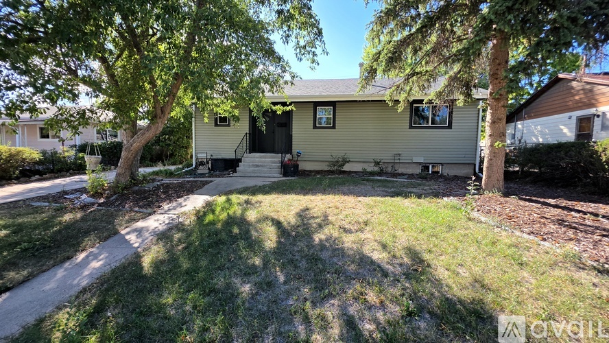 A house with a tree in front of it is for sale.