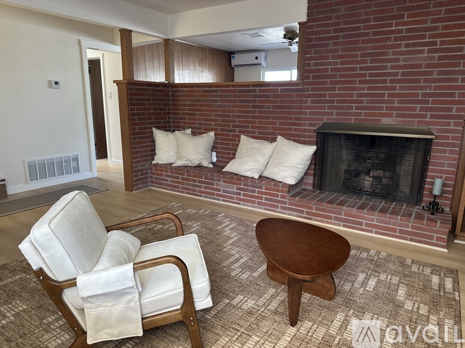 A living room with a fireplace and a chair.