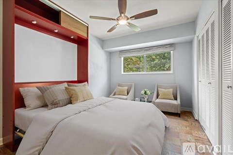 A bedroom with a large bed and a window with a view of trees.