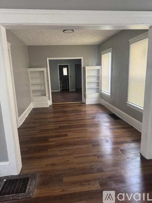 A room with wooden floors and white walls.