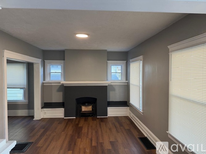 A living room with a fireplace and a window.