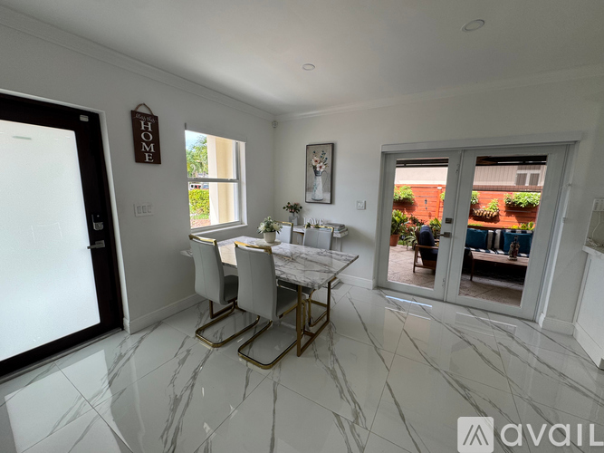 A dining room with a marble floor and a table set for two.