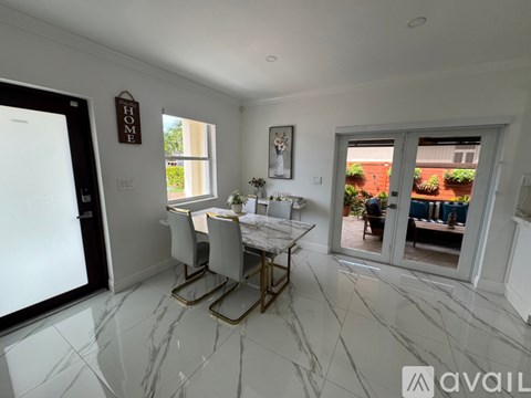 A dining room with a marble floor and a table set for two.