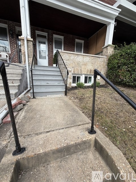 A house with a front porch and stairs leading to the door.