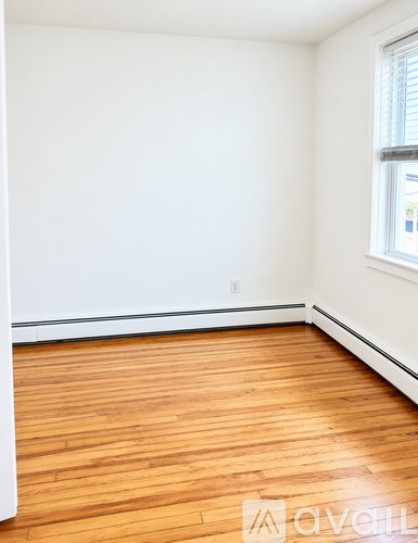 A room with wooden floors and white walls.