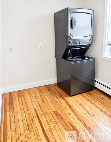 A black microwave oven is on top of a black stove.