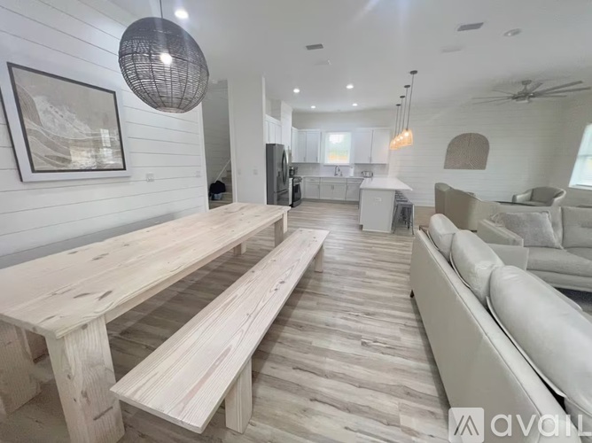 A modern living room with a long wooden table and benches.