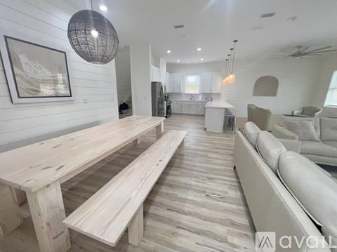 A modern living room with a long wooden table and benches.
