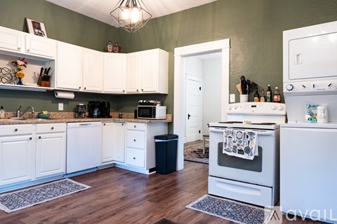 A kitchen with white cabinets and a white oven.