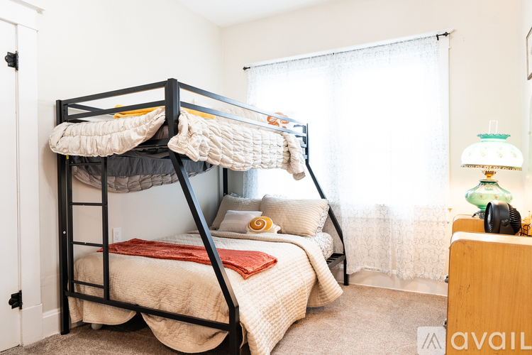 A bedroom with a bunk bed and a desk.