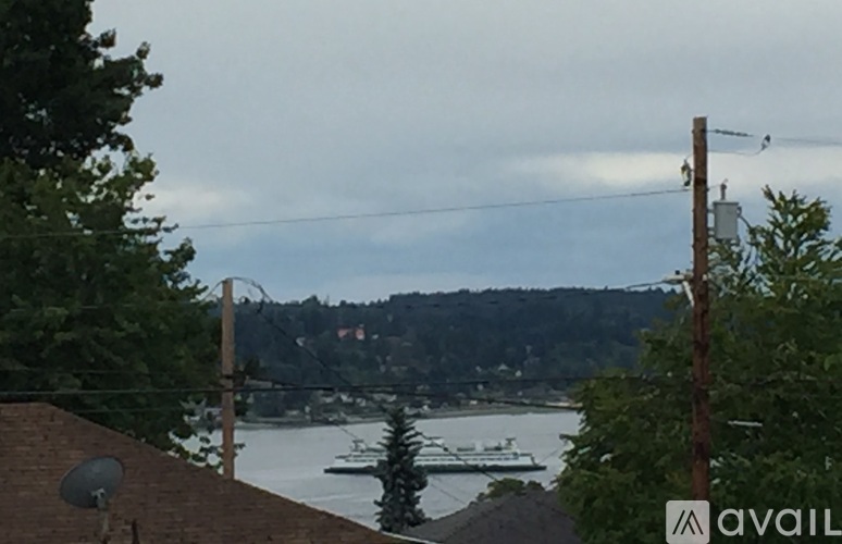 A view of a body of water with boats and a town in the distance.