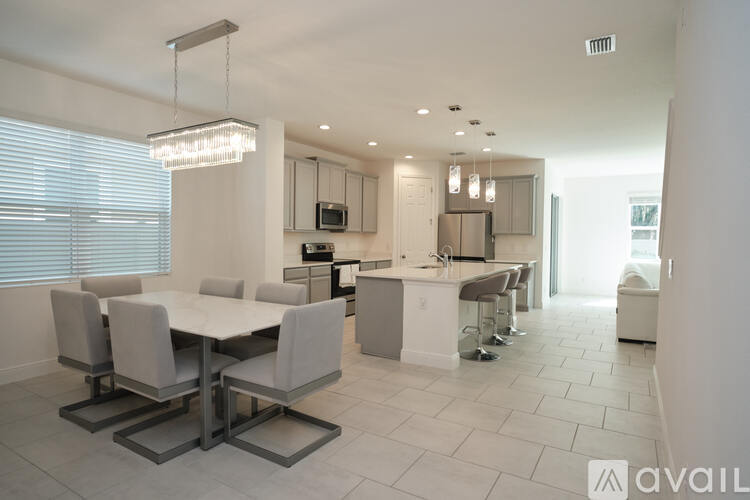 A modern kitchen with a dining table and chairs.