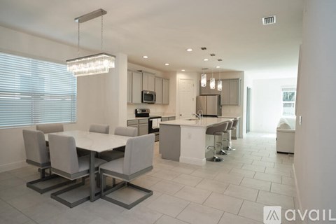 A modern kitchen with a dining table and chairs.