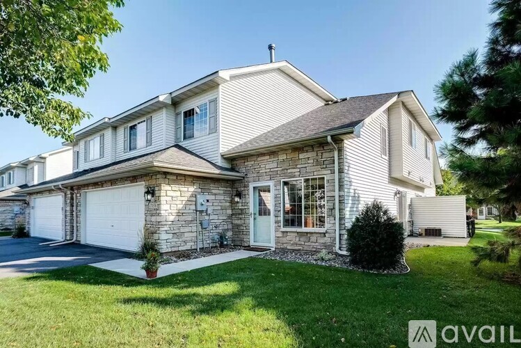 A house with a garage and a driveway is for sale.