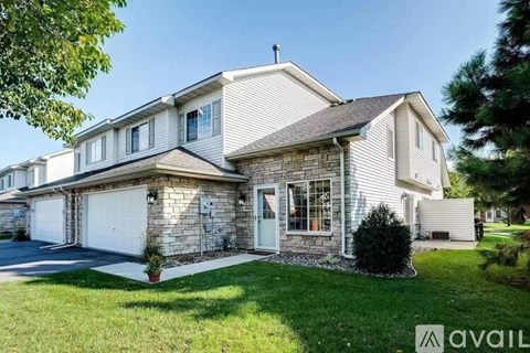 A house with a garage and a driveway is for sale.