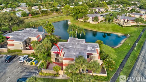 A red arrow points to a building with a pool in front of it.