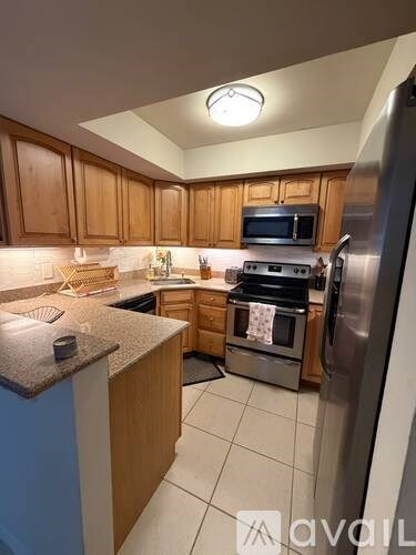 A kitchen with wooden cabinets and stainless steel appliances.