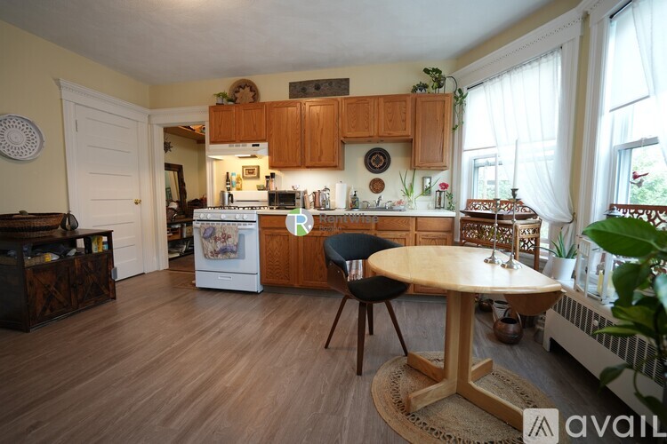 A kitchen with wooden floors and furniture.