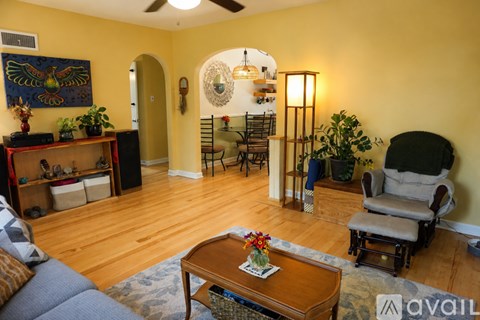 A living room with a blue couch and a wooden coffee table.