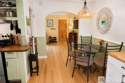 A kitchen with a table and chairs in the middle of the room.